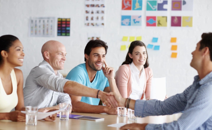 professional partners handshake in bright office